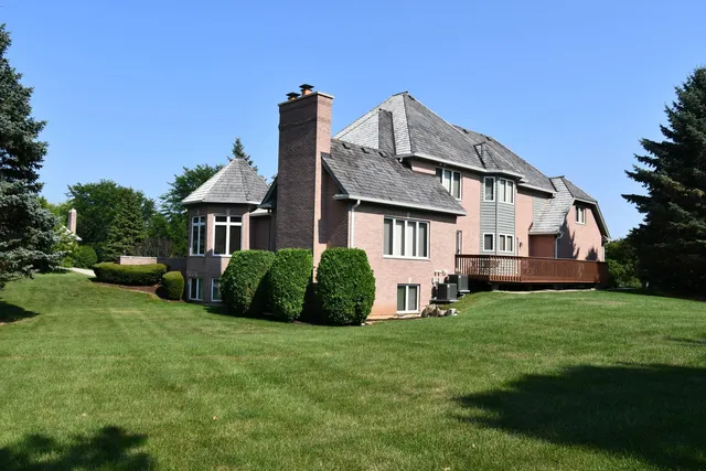 a front view of a house with a garden and yard