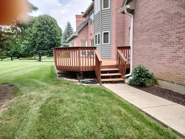 a view of a house with a garden and deck