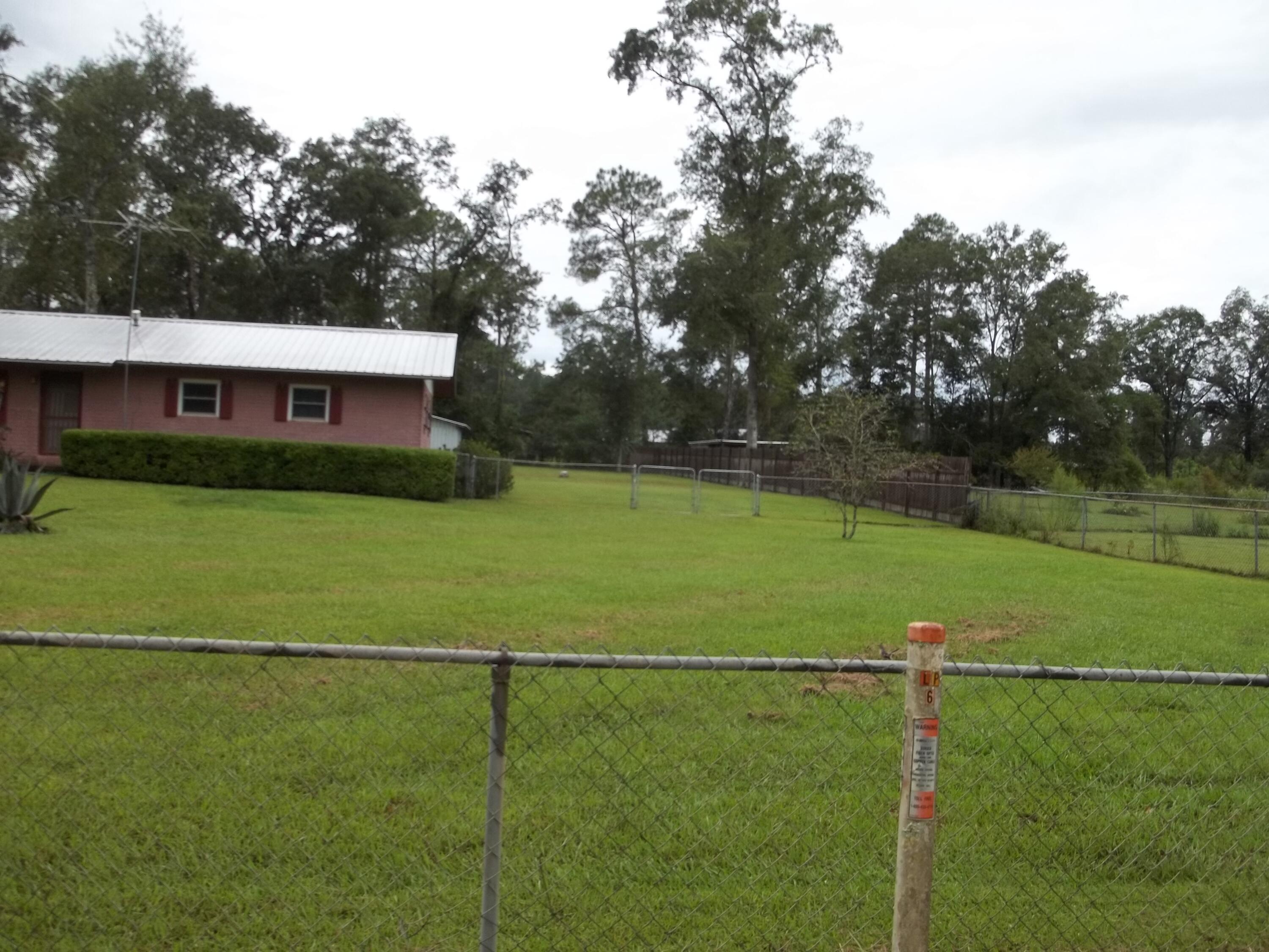 1516 Foxworth Road Chipley, FL 32428 - Photo 5 of 28 a view of a house with a backyard
