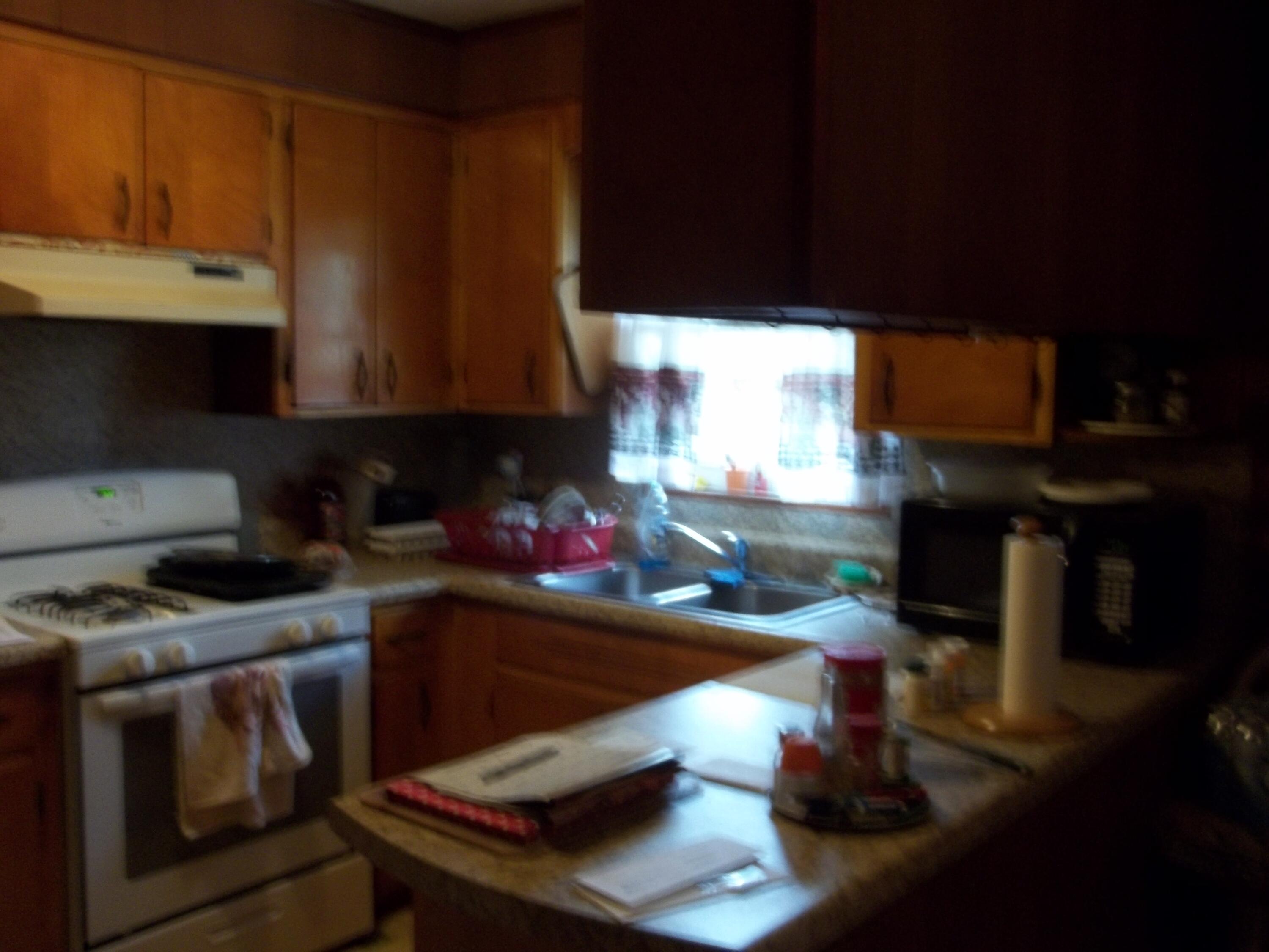 1516 Foxworth Road Chipley, FL 32428 - Photo 10 of 28 a kitchen with a sink a stove and a microwave