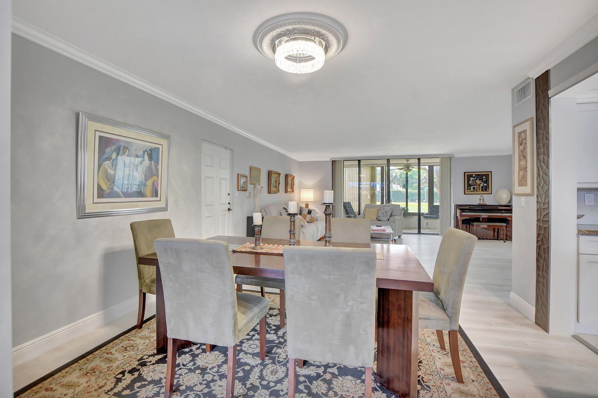 7194 Promenade Drive, Unit 102 Boca Raton, FL 33433 - Photo 10 of 56 a view of a dining room with furniture