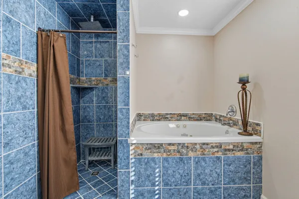 a bathroom with a toilet a sink a mirror and a window