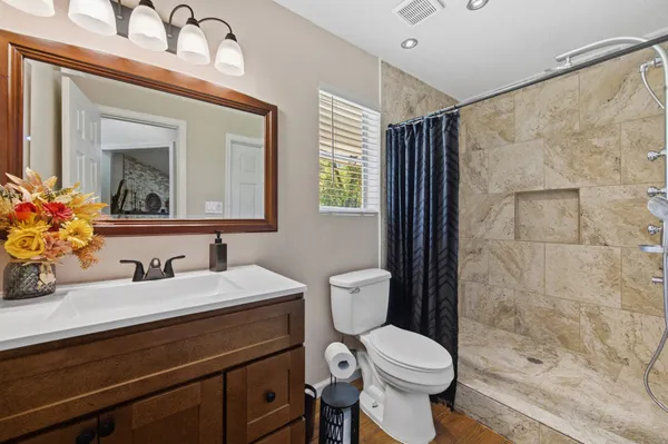 a bathroom with a shower and a sink