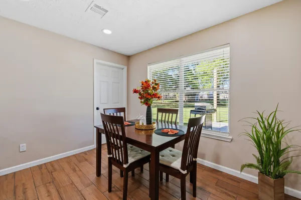 a view of a dining room with furniture window and wooden floor