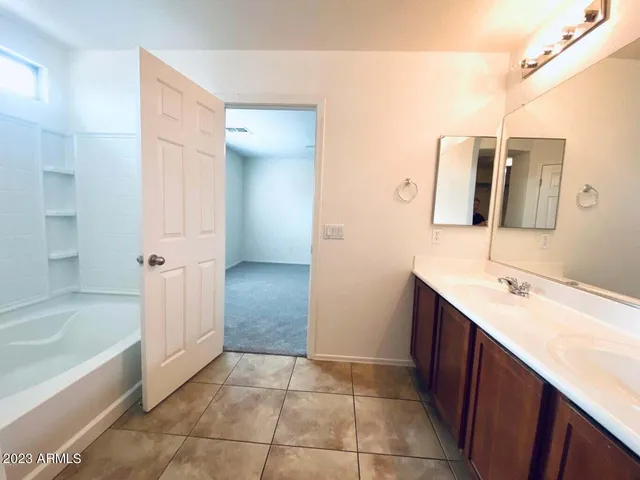 a bathroom with a double vanity sink and mirror