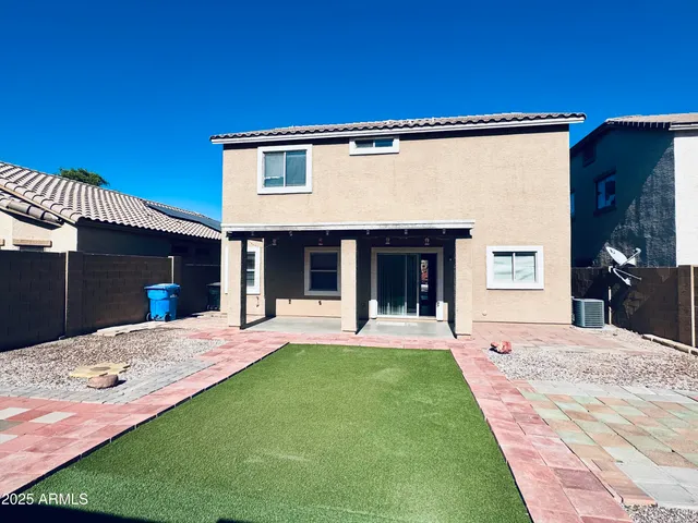 a front view of a house with a garden and yard