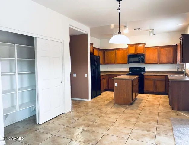 a kitchen with stainless steel appliances granite countertop a stove a sink a counter space and cabinets