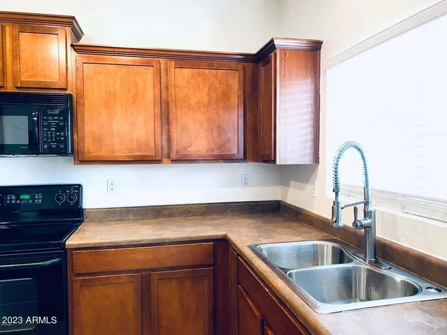 a kitchen with a sink and a microwave
