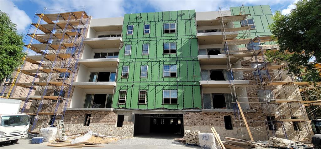15875 Spectrum Drive, Unit 1106 Addison, TX 75001 - Photo 1 of 1 a front view of a building with a garden