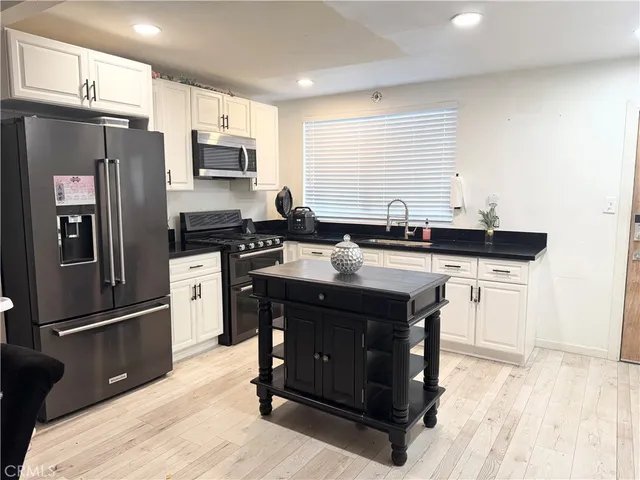 a dining room with a table chairs and kitchen view