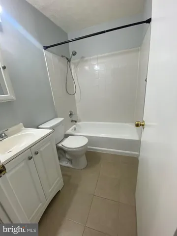 a bathroom with a sink toilet and mirror