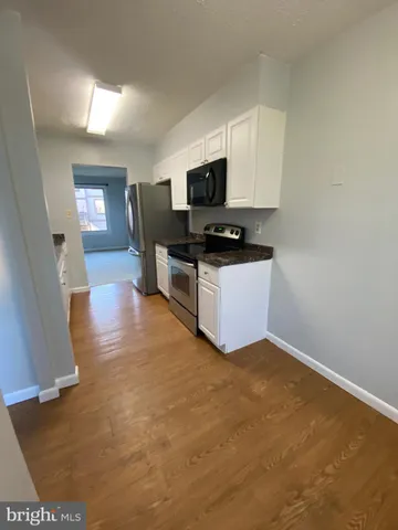 a view of a kitchen with microwave and cabinets