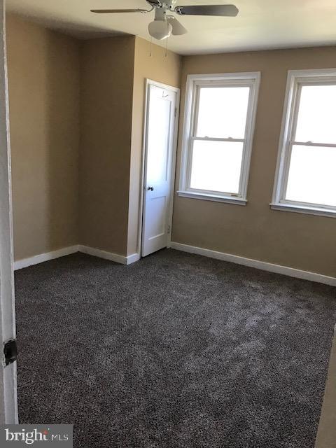 2 Yorkway Dundalk, MD 21222 - Photo 3 of 8 an empty room with windows and chandelier fan
