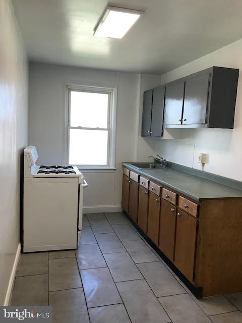 2 Yorkway Dundalk, MD 21222 - Photo 4 of 8 a kitchen with a sink a stove and cabinets