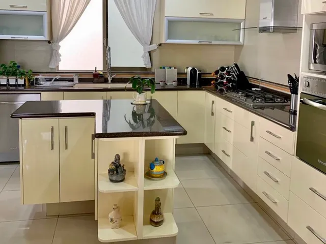 a kitchen with a sink a stove and cabinets