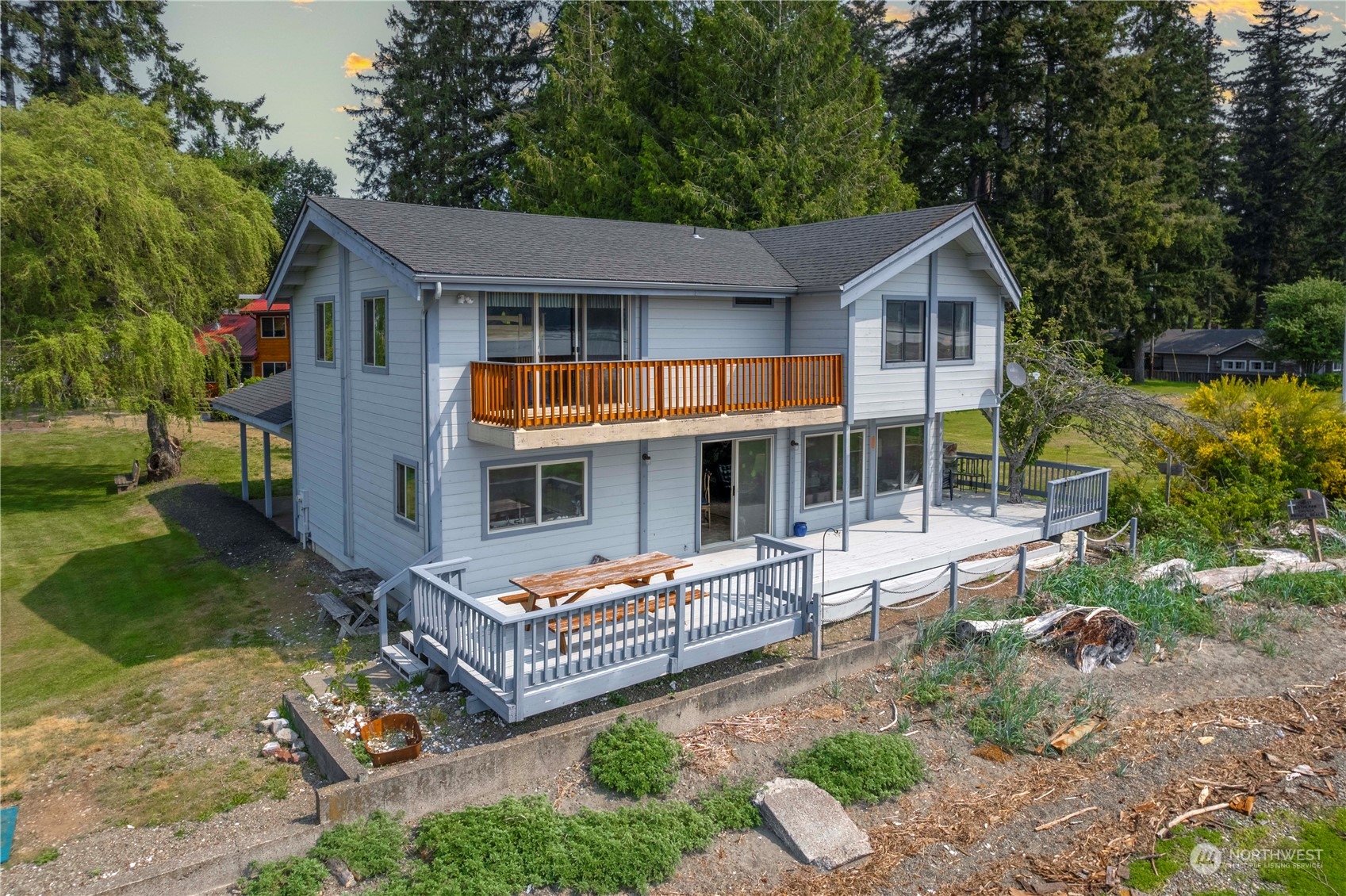 191 Northeast Wagon Wheel Road Belfair, WA 98528 - Photo 22 of 27 a view of house with a big yard and large trees