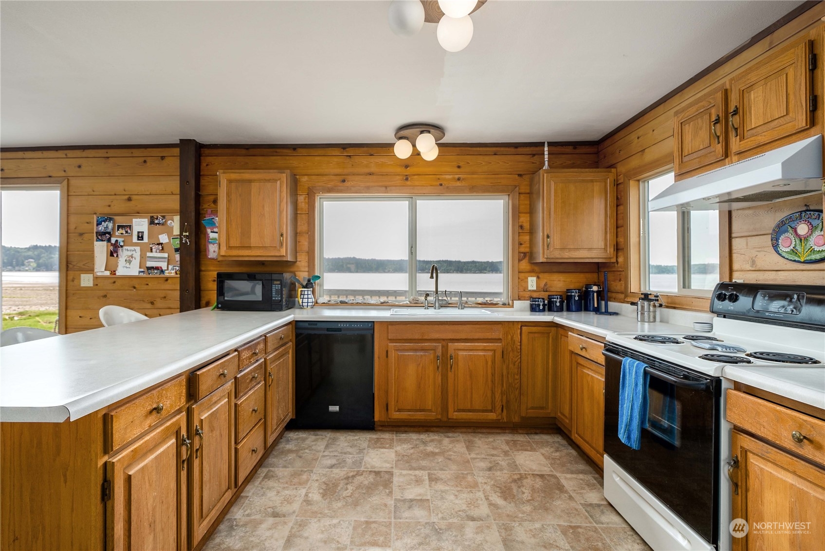 191 Northeast Wagon Wheel Road Belfair, WA 98528 - Photo 4 of 27 a kitchen with stainless steel appliances granite countertop a stove a sink and a microwave