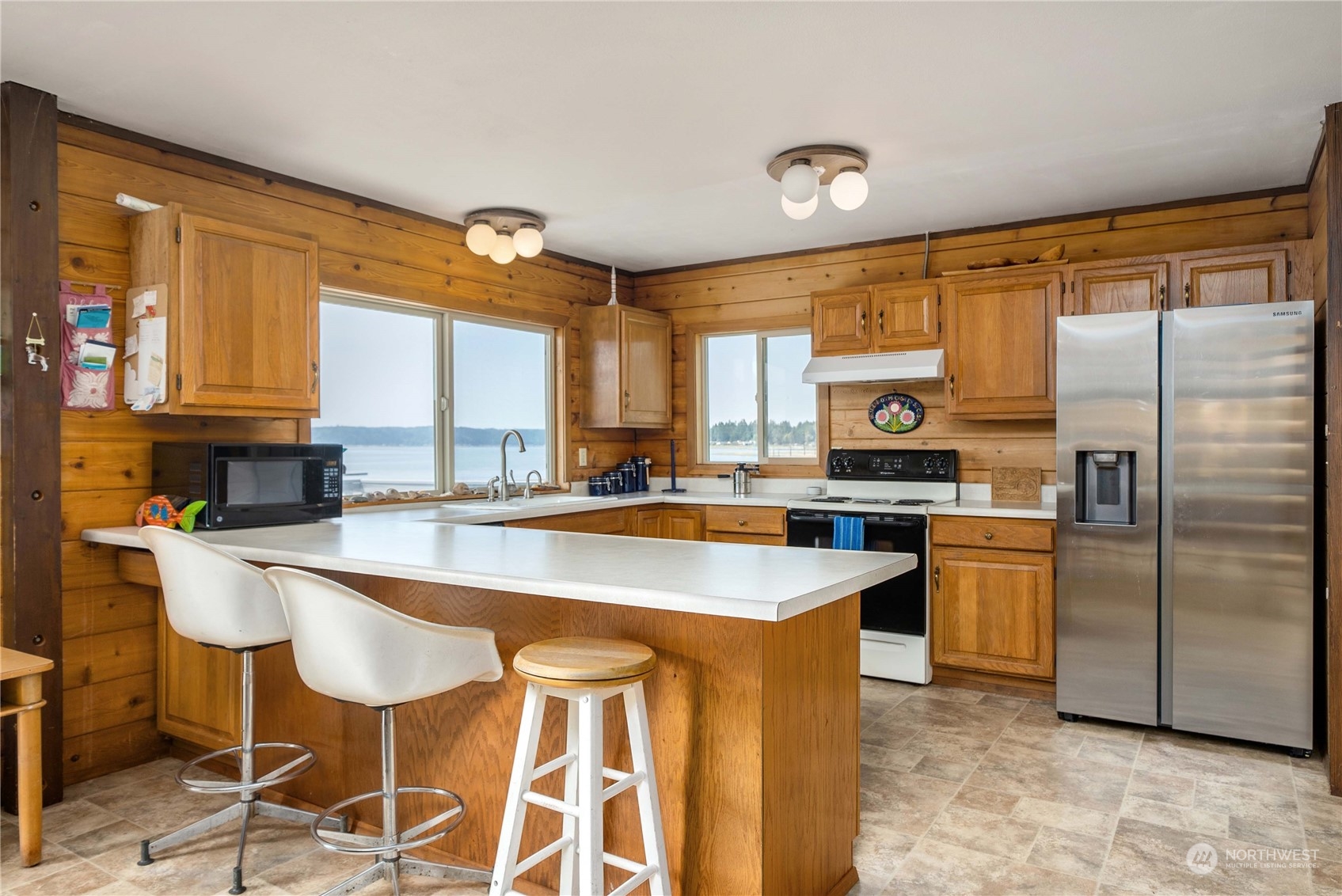 191 Northeast Wagon Wheel Road Belfair, WA 98528 - Photo 5 of 27 a kitchen with stainless steel appliances granite countertop a sink a stove and a refrigerator