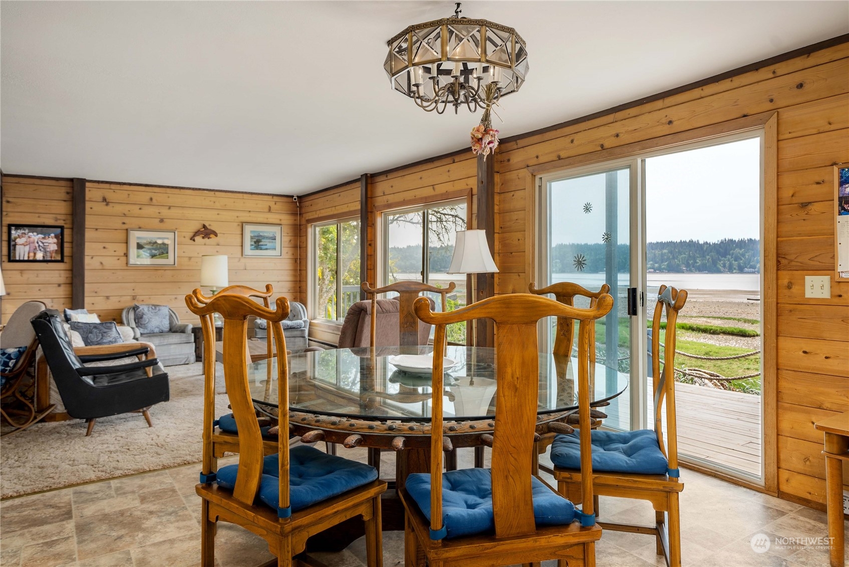 191 Northeast Wagon Wheel Road Belfair, WA 98528 - Photo 8 of 27 a view of a dining room with furniture a chandelier and wooden floor