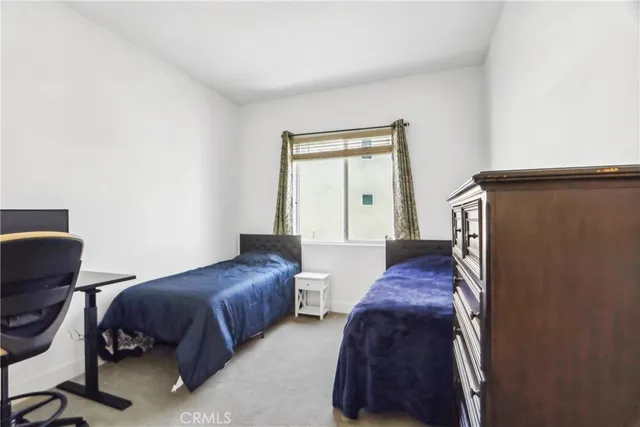 a bedroom with a bed and chair