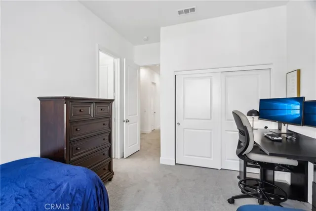 a bedroom with a bed and a chair