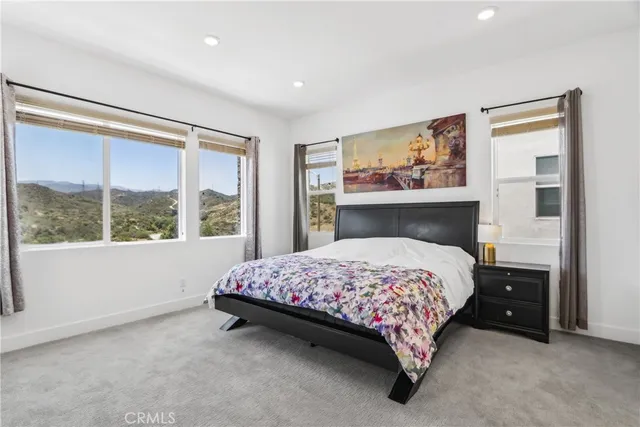 a bedroom with a bed and a large window