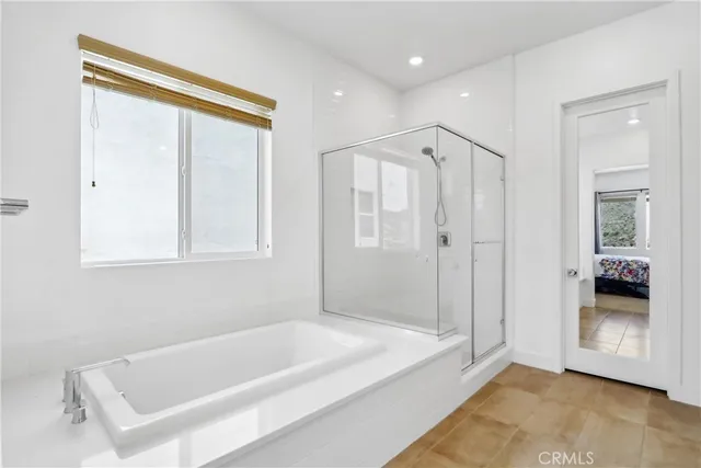 a bathroom with a bathtub and a shower