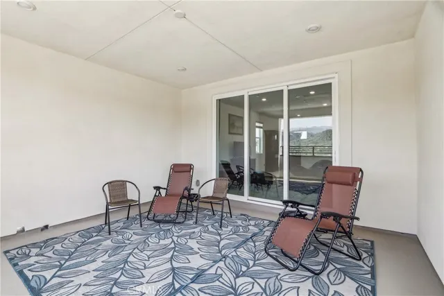 a work room with furniture and floor to ceiling window
