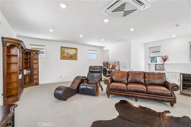 a living room with furniture a ceiling fan and a rug