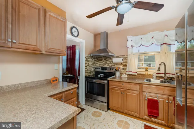 a kitchen with stainless steel appliances granite countertop a stove and cabinets