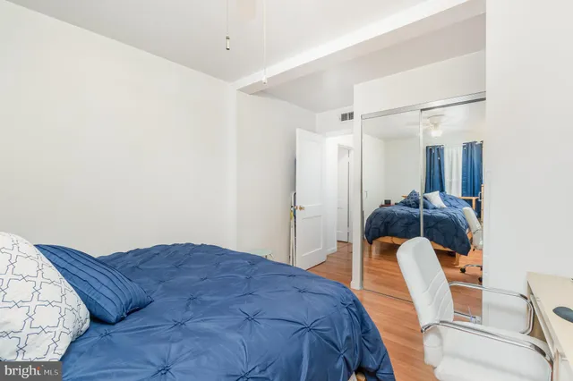 a bedroom with a bed and a mirror