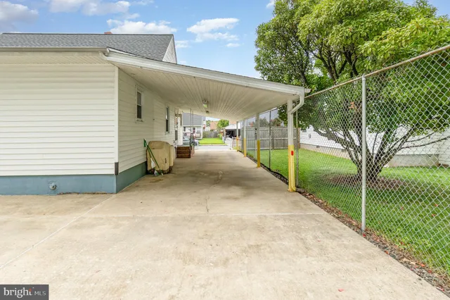 a view of a patio with table and chairs and floor to ceiling window