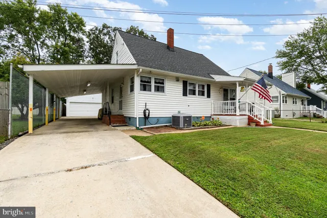 a front view of a house with a garden and yard