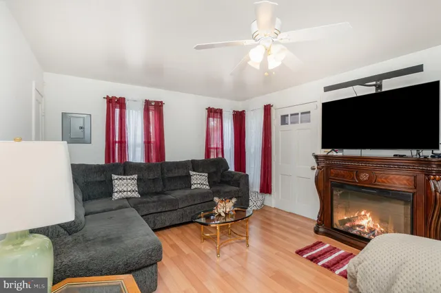 a living room with furniture fireplace and flat screen tv