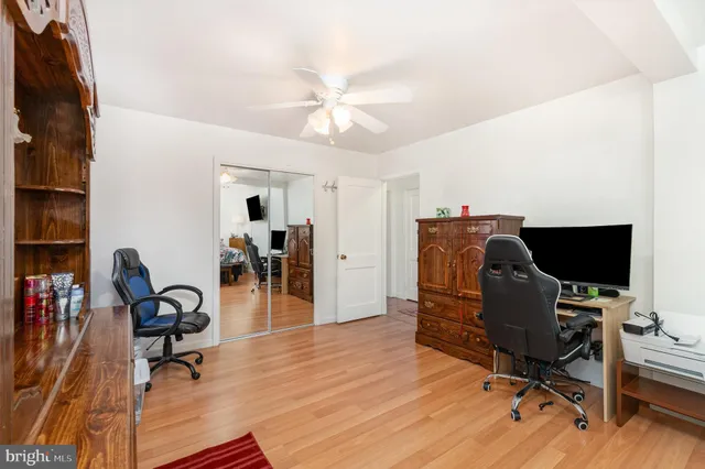 a view of a workspace with furniture and wooden floor