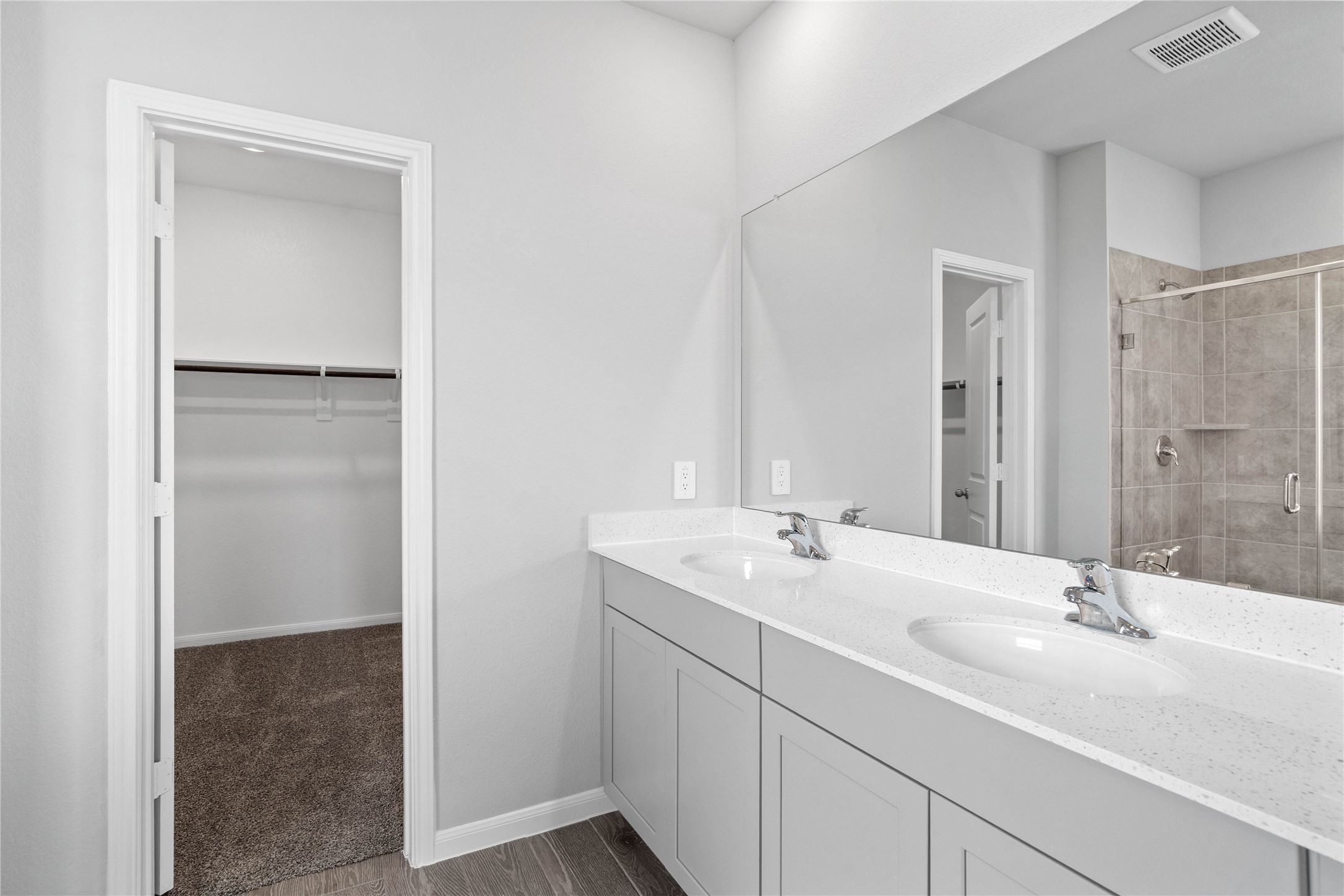 19657 Montgomery Rdg Way Montgomery, TX 77316 - Photo 29 of 49 Modern primary bath features dual vanities with sleek cabinetry, a quartz countertop, and chrome fixtures for a truly contemporary feel.