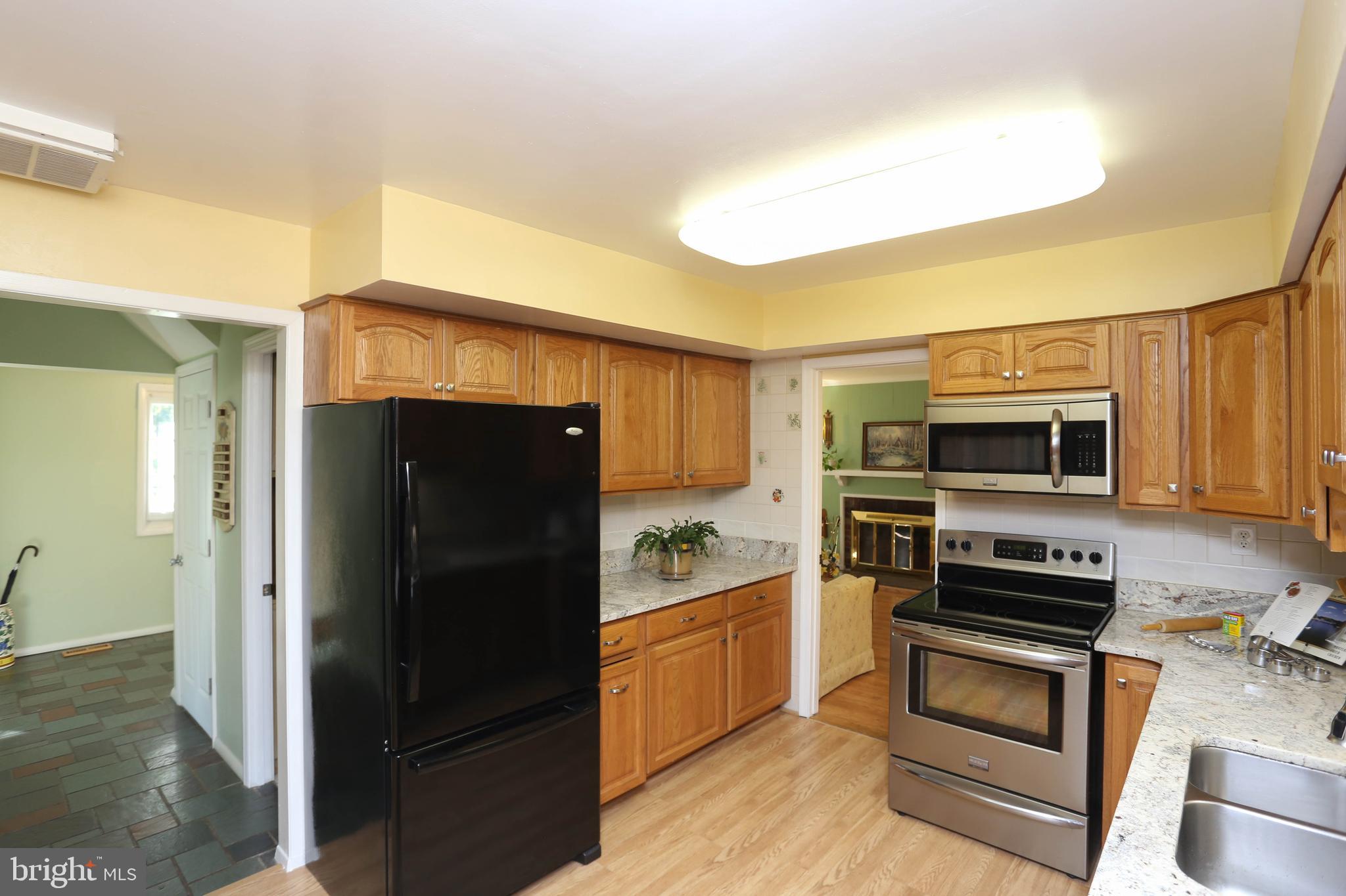 9110 Montpelier Drive Laurel, MD 20708 - Photo 11 of 30 a kitchen with a refrigerator stove and microwave