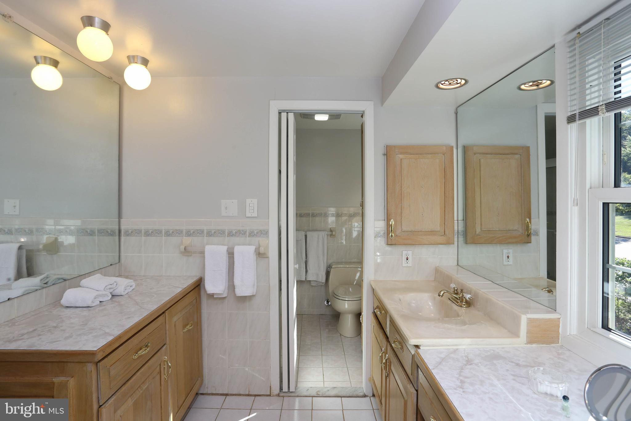 9110 Montpelier Drive Laurel, MD 20708 - Photo 15 of 30 a bathroom with a granite countertop sink a toilet and shower
