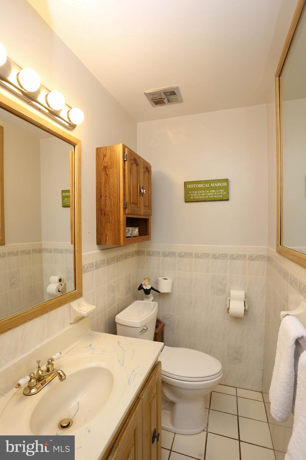 9110 Montpelier Drive Laurel, MD 20708 - Photo 16 of 30 a bathroom with a granite countertop sink mirror vanity and toilet