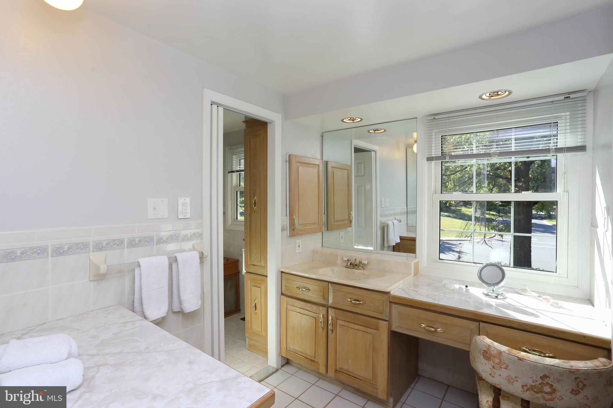 9110 Montpelier Drive Laurel, MD 20708 - Photo 17 of 30 a bathroom with a granite countertop sink mirror and a toilet