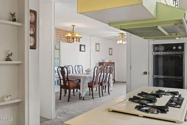 a dining room with furniture and a chandelier