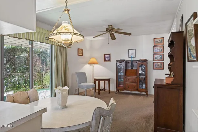 a living room with furniture a window and a chandelier
