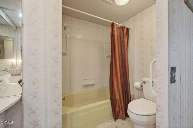 a bathroom with a shower and a toilet