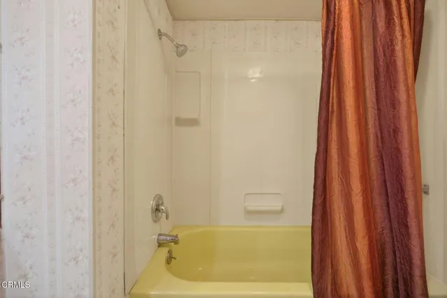 a bathroom with a shower curtain and a sink