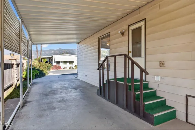 a view of a porch with wooden stairs