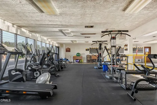 a view of a hall with the floor and chandelier