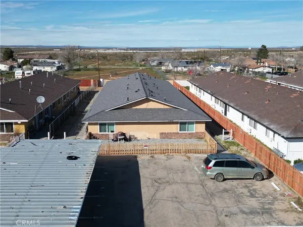 an aerial view of a house with car parked