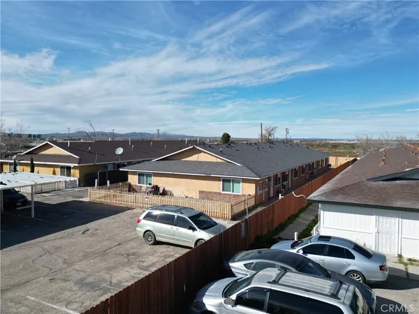 an aerial view of residential houses with outdoor space