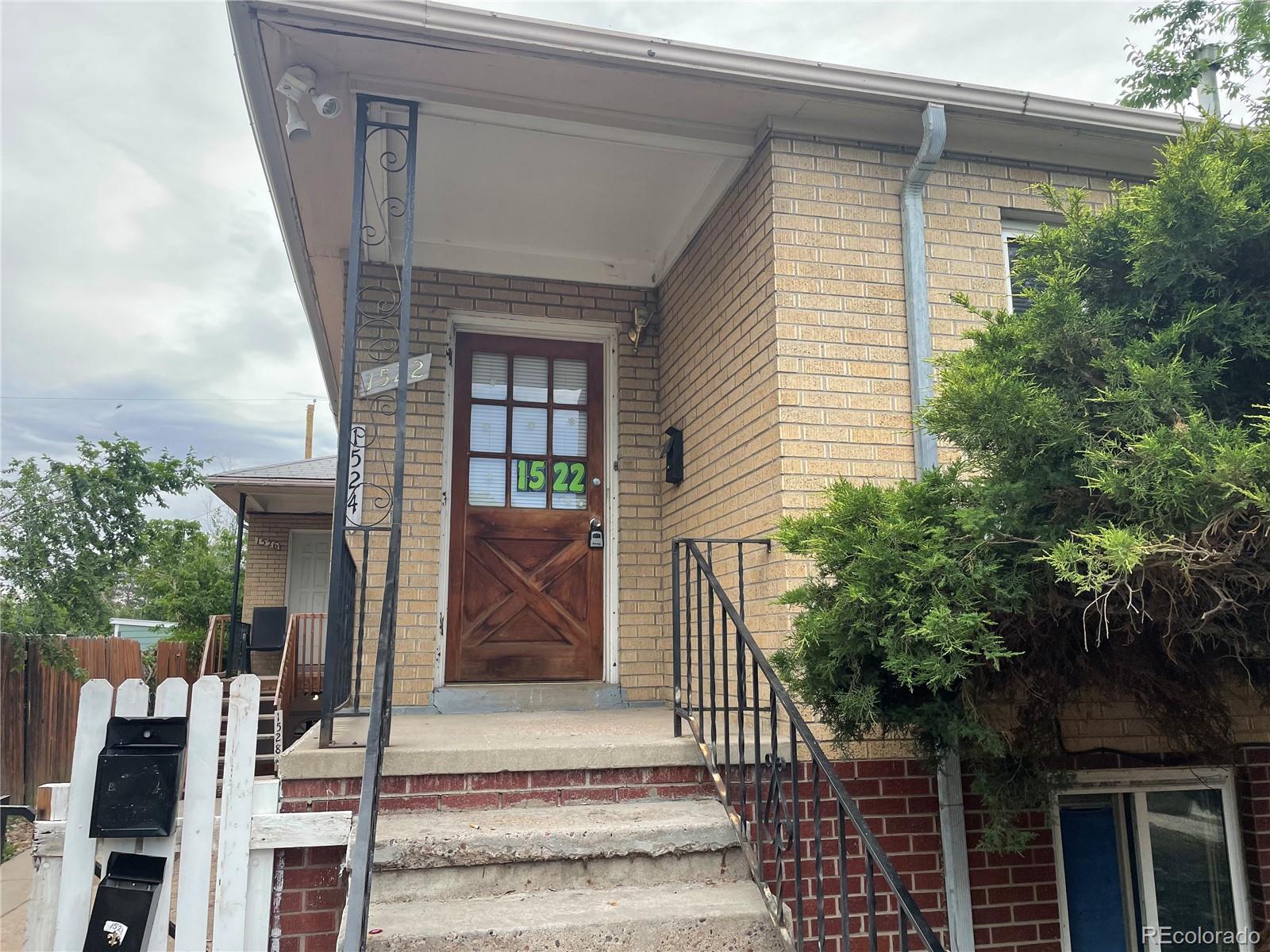 1528 Ulster Street Denver, CO 80220 - Photo 1 of 8 a front view of a house with garage