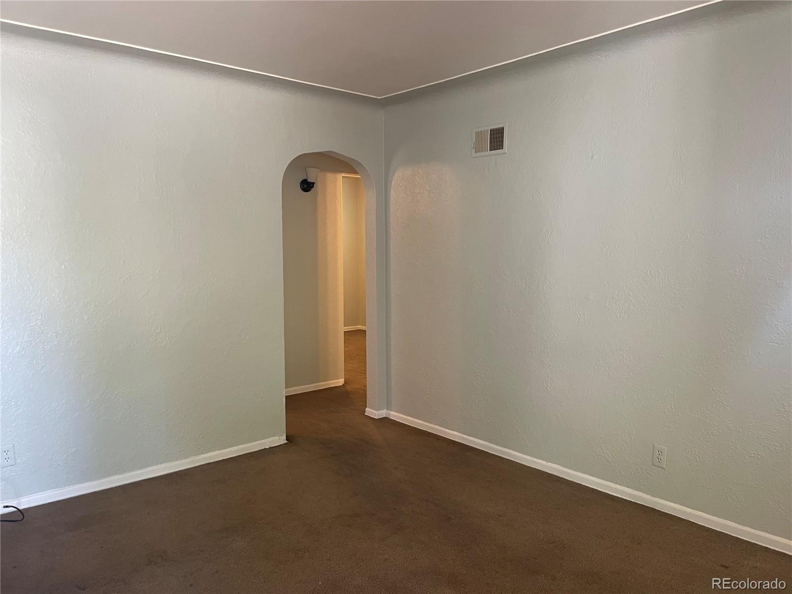 1528 Ulster Street Denver, CO 80220 - Photo 6 of 8 an empty room with a door